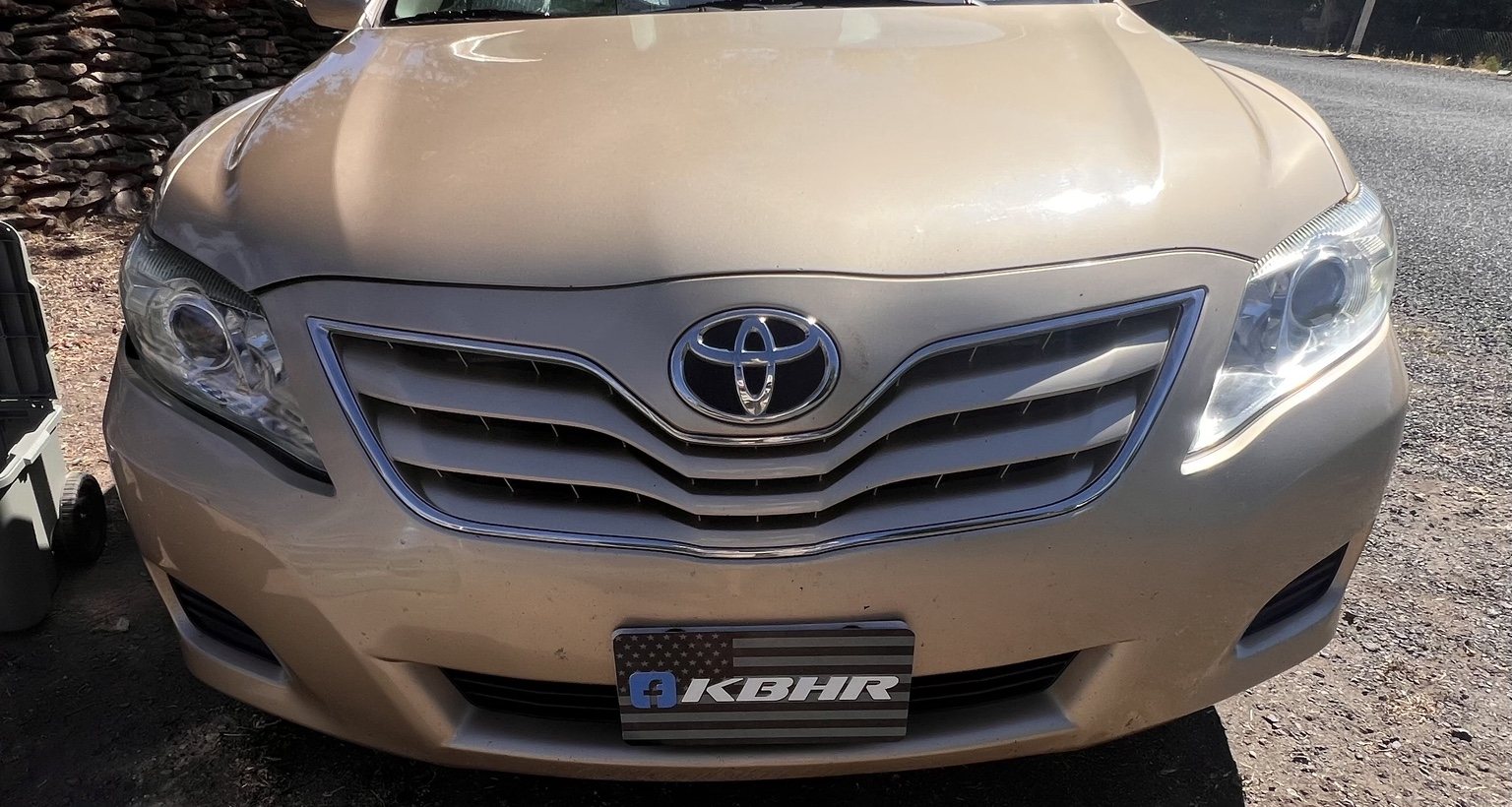 Gold Toyota Camry with restored clear headlights after KBHR headlight restoration in Klamath Falls Oregon