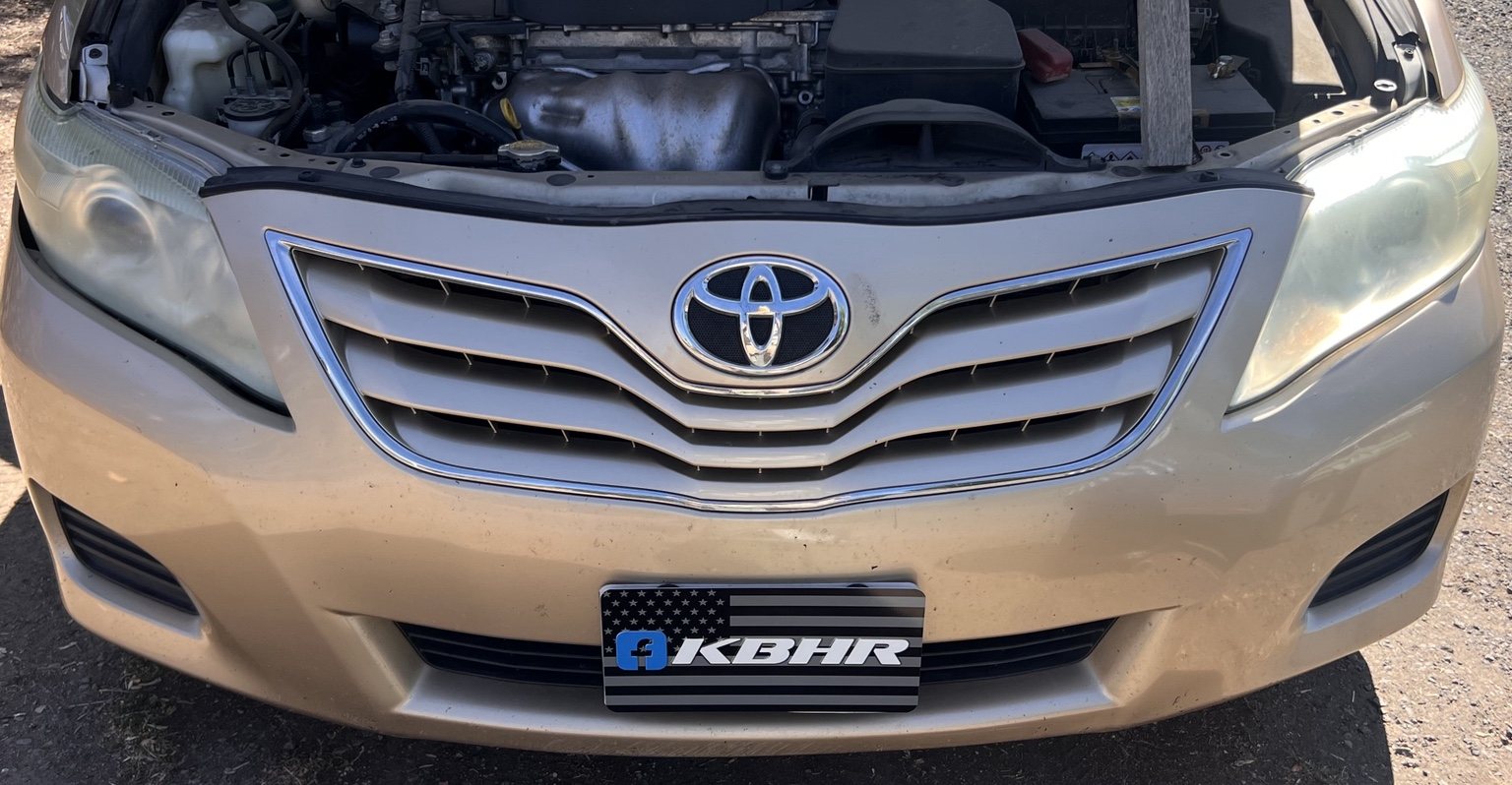 Gold Toyota Camry with cloudy oxidized headlights before KBHR headlight restoration in Klamath Falls Oregon