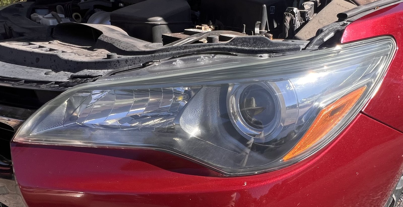 Close-up of restored red Toyota Camry headlight after KBHR service
